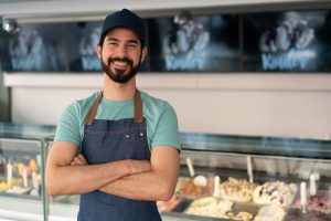 Portrait of smiling salesman at the ice cream parlor